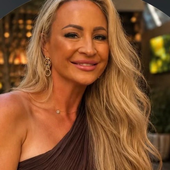 Ashley, smiling, in a portrait taken indoors